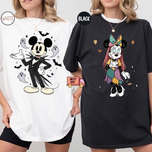 May include: White and black t-shirts featuring Disney characters in Halloween costumes. One shirt has Mickey Mouse dressed as Jack Skellington, surrounded by bats and ghosts. The other shirt has Minnie Mouse in a patchwork dress with autumn leaves.