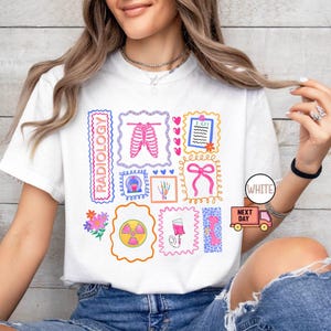 May include: White t-shirt featuring colorful illustrations related to radiology. The design includes images of a rib cage, an X-ray, a heart, and other medical-themed graphics. The word "RADIOLOGY" is printed vertically.