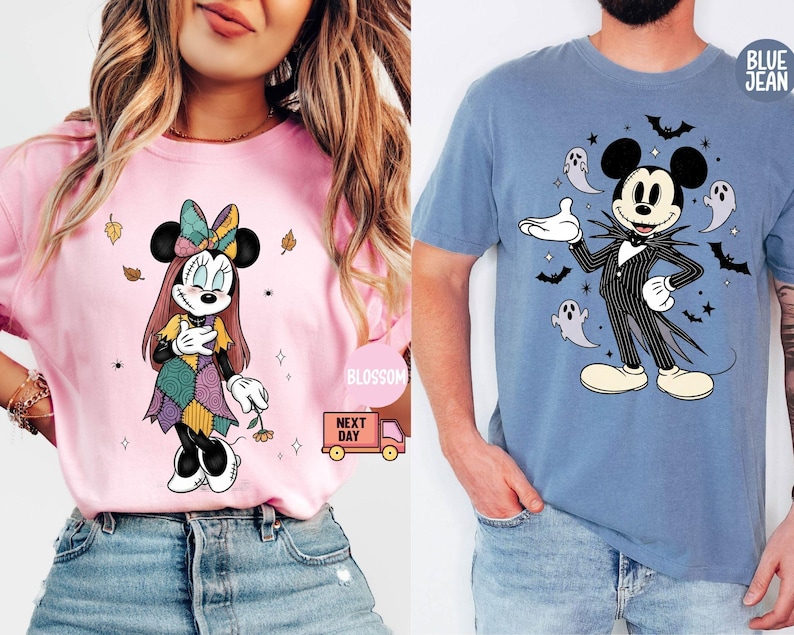 May include: Two t-shirts featuring Disney characters. One is pink with Minnie Mouse in a Halloween costume. The other is blue with Mickey Mouse dressed as Jack Skellington, surrounded by bats and ghosts.