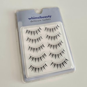 May include: A package of six pairs of delicate false eyelashes from the brand whimsibeauty.