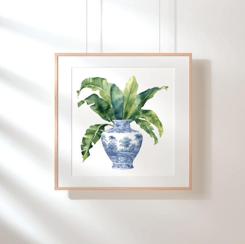 Puede incluir: Una pintura de acuarela de un jarr&oacute;n de porcelana azul y blanco con una planta verde frondosa en su interior. El jarr&oacute;n tiene un dise&ntilde;o floral y la planta tiene hojas grandes y tropicales.