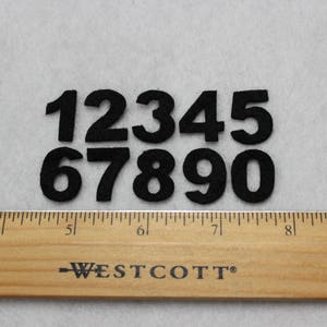 May include: Black felt numbers 1 through 0, arranged in two rows. The numbers are approximately 2 inches tall.