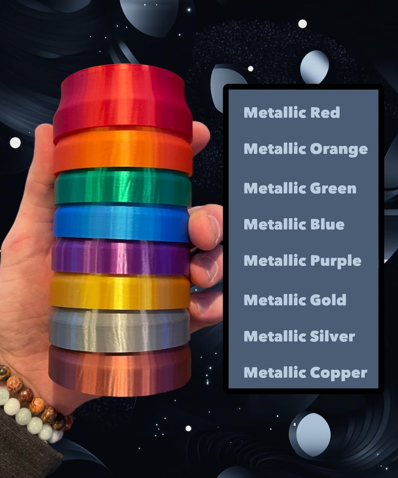 May include: A stack of eight round, metallic colored plastic discs. The colors are red, orange, green, blue, purple, gold, silver, and copper. The discs are stacked in order from top to bottom, with the red disc on top and the copper disc on the bottom.