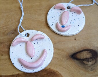 Sculpted happy face handmade clay ornament | pink | car charm | holiday ornament | Christmas ornament | ceramic | stocking stuffer