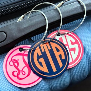 Small Monogrammed Metal Luggage Tag.  Double Sided tag with a choice of 3 monogram styles and endless color combos.  Great for suitcases, backpacks, computer bags, Duffles and gym Bags.  Attaches with wire locking loop.  Contact info printed on back.