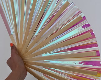May include: A hand fan made of bamboo and iridescent plastic. The fan is open and has a rainbow-like sheen.