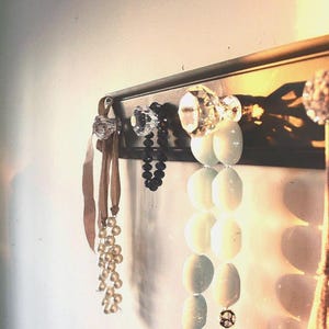 Black distressed glass knob rack