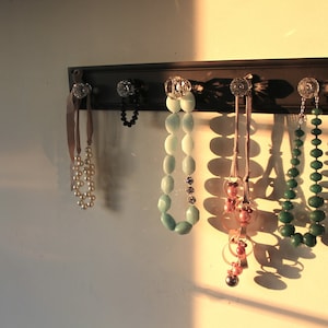 Black distressed glass knob rack