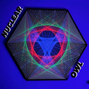 May include: A geometric string art piece in a black hexagonal frame. The design features a central blue triangle surrounded by red and green lines, with the words "NUCLEAR" and "OWL" in white text.