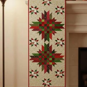 May include: A rectangular Christmas table runner with a cream background and a repeating pattern of red and green starbursts. The centre features a large starburst design in red, green, and brown. The edges are trimmed with a red border.
