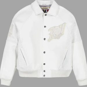 May include: A white varsity-style jacket featuring a classic collar, snap-button front closure, and ribbed cuffs and hem. The garment includes perforated side panels, two slanted front pockets, and a large embroidered patch on the left chest.