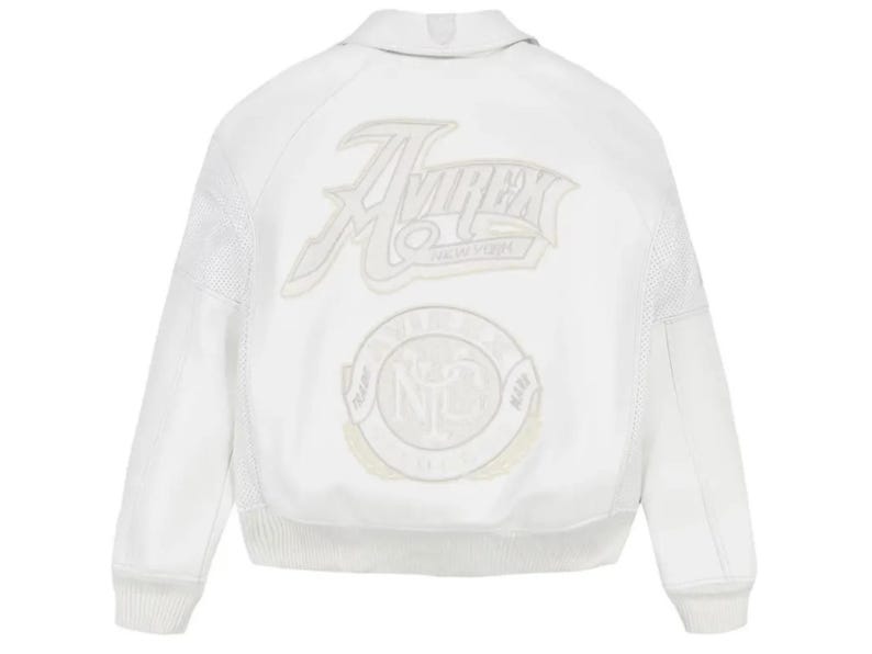 May include: A white bomber jacket featuring tonal embroidery on the back. The design includes the text Avirex New York in a stylized script font above a circular emblem with the letters NYC and the words Trade Mark surrounding the center.