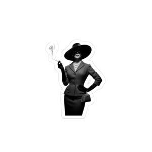 May include: Monochrome sticker of a woman in a suit, wide-brimmed hat, and gloves, smoking a cigarette. She wears a pearl necklace and carries a small handbag. The image has a vintage, classic style.