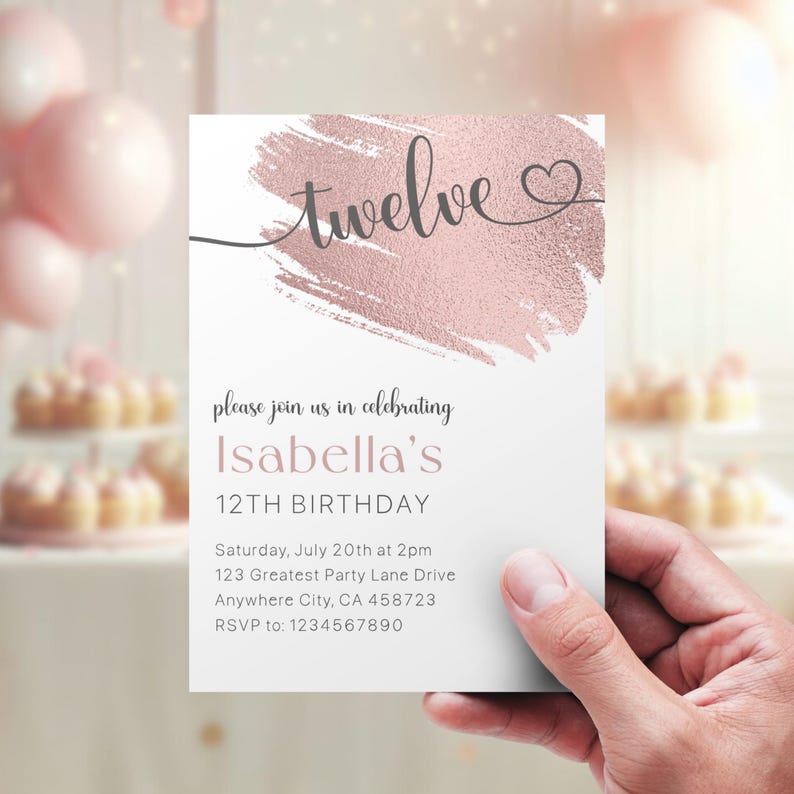 May include: A white invitation card with a pink and gold brushstroke design. The text "twelve" is written in cursive with a heart symbol. The invitation is for Isabella's 12th birthday party. The party details are listed below: Saturday, July 20th at 2pm, 123 Greatest Party Lane Drive, Anywhere City, CA 458723. RSVP to: 1234567890.