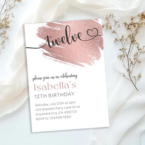 May include: A white invitation with a rose gold brushstroke design. The text "twelve" is written in cursive with a heart symbol. The invitation is for Isabella's 12th birthday party. The party is on Saturday, July 20th at 2pm at 123 Greatest Party Lane Drive, Anywhere City, CA 458723. RSVP to 1234567890.