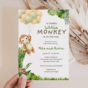 May include: Baby shower invitation featuring a watercolor illustration of a monkey holding balloons. The text reads "a cheeky little MONKEY is on the way" with details for Mike and Olivia's baby shower. Tropical foliage and floral accents frame the design.