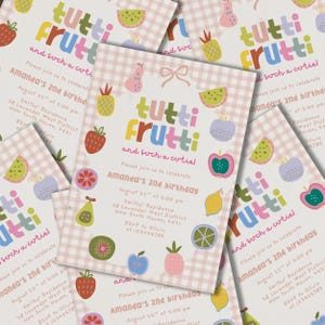 May include: A stack of colorful invitations with a Tutti Frutti theme. The invitations feature a pink and white checkered background, fruit illustrations, and text that reads "Amanda's 2nd Birthday".