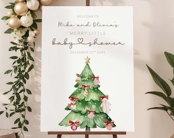 May include: A white sign on a wooden easel with the text "Welcome to Mike and Olivia's Merry Little Baby Shower" and the date December 22nd 20XX. The sign features a watercolor Christmas tree decorated with ornaments and bows.