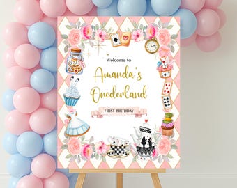 May include: A pink and white welcome sign with a whimsical Alice in Wonderland theme. The sign features a gold inscription that reads "Welcome to Amanda's Onederland First Birthday".
