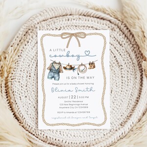 May include: Baby shower invitation with a cowboy theme. The invitation features a rope border and a watercolor illustration of cowboy attire, including overalls, a hat, and boots. The text reads "A Little Cowboy Is On The Way."