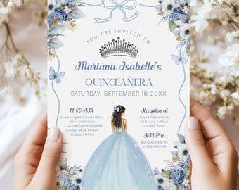 May include: A blue and white quinceañera invitation with a floral design and a crown. The invitation includes the text "You are invited to Mariana Isabelle's Quinceañera Saturday, September 16, 20XX".