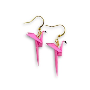 May include: A pair of pink origami flamingo earrings with gold hooks.