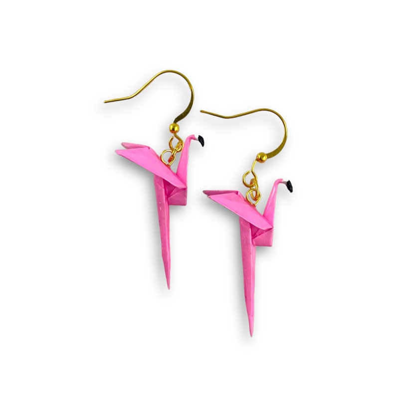 May include: A pair of pink origami flamingo earrings with gold hooks.