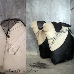 May include: Three handmade fabric toys, two black and white with a white face and black ears and one white with a black face and ears. The toys are all wearing a white fabric ribbon around their necks.