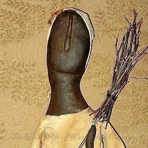 May include: A handmade rag doll with a brown face, white bonnet, and a long brown dress. The doll is holding a bundle of twigs in its right hand.