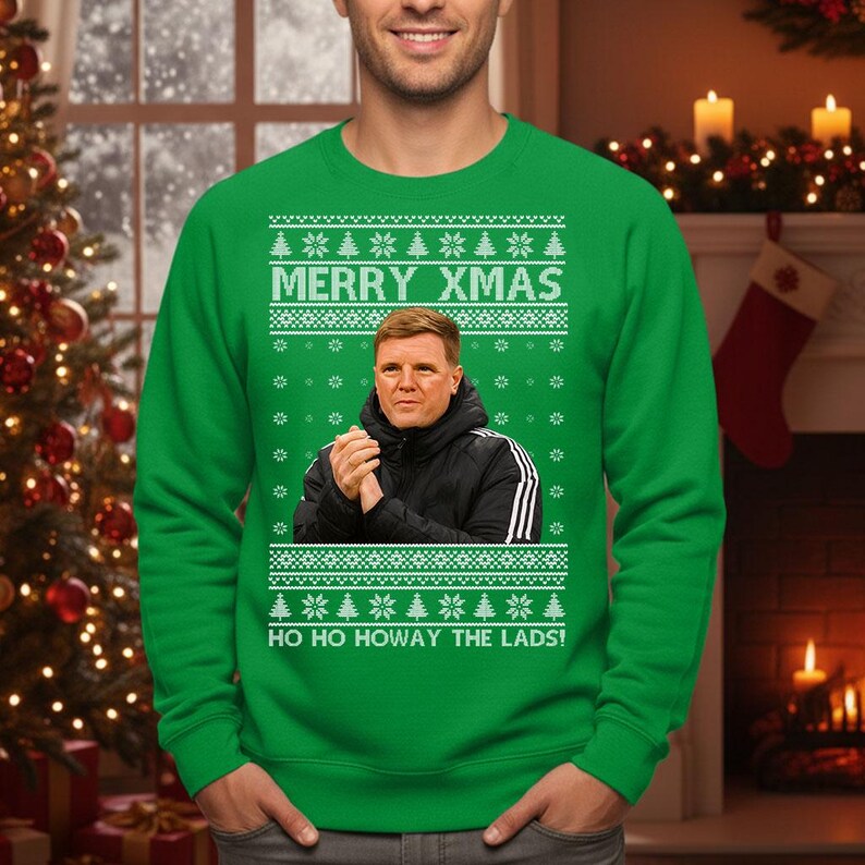 May include: Green Christmas sweater with the text "MERRY XMAS" and "HO HO HOWAY THE LADS!". The sweater features a portrait of a man in a black jacket. The sweater has a festive pattern of snowflakes and Christmas trees.