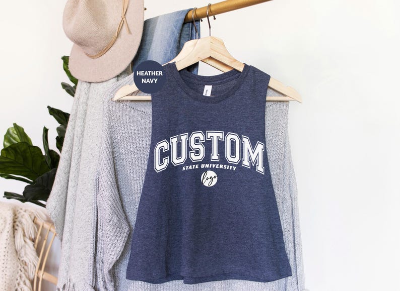 a t - shirt that says custom hanging on a clothes rack