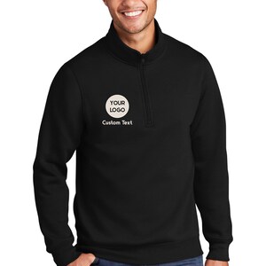 a man wearing a black sweatshirt with a white logo on it