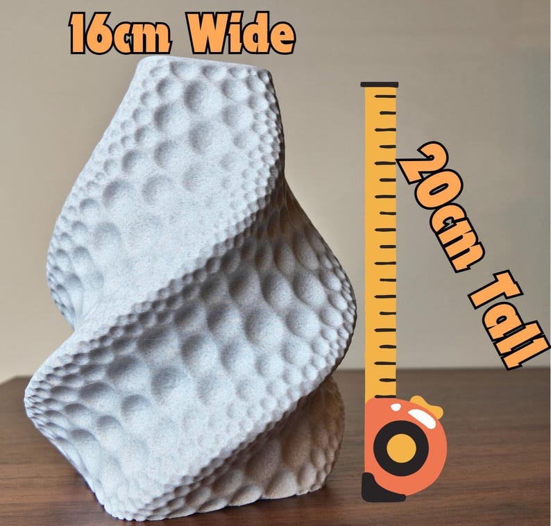 May include: A gray, textured vase with a unique, twisted design. The vase is 16cm wide and 20cm tall (6.3 inches wide and 7.9 inches tall). The surface has a pattern of small, raised bumps. The text on the image reads "16cm Wide" and "20cm Tall".