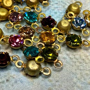 May include: A set of three ceramic mugs with a speckled, matte finish. The mugs are in shades of cream, light gray, and dark gray. Each mug has a simple, minimalist design and a rounded handle.