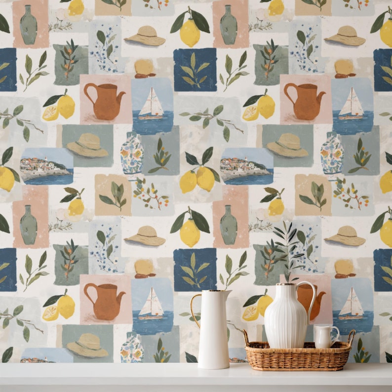May include: A repeating pattern of square blocks featuring watercolor illustrations of lemons, hats, sailboats, vases, and foliage. The color palette includes yellow, blue, green, and beige, creating a summery, Mediterranean theme. The design is suitable for wallpaper or fabric.