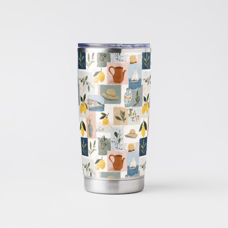 May include: A stainless steel travel tumbler with a colorful, patterned design. The pattern features a collage of lemons, teapots, hats, and sailboats in a grid of squares. The tumbler has a silver base and a dark blue lid.
