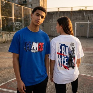 May include: Two people wearing t-shirts with "FRANCE" printed on them. One shirt is blue with the word in red, white, and blue. The other shirt is white with a similar design on the back. The shirts have the text "KAISER FC" on them.