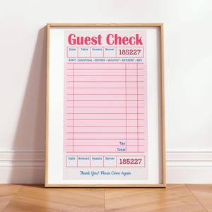 May include: A framed wall art print featuring a vintage-style pink guest check with red text reading Guest Check and 185227. The form includes blue headers for date, table, guests, server, and categories like soup, salad, entree, and dessert, ending with Thank You! Please Come Again.