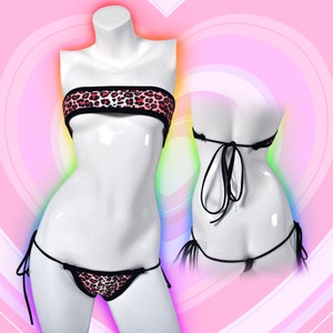 May include: A black and pink leopard print bikini top and matching bottom with adjustable straps. The bikini top is a bandeau style and the bottom has a low rise cut.