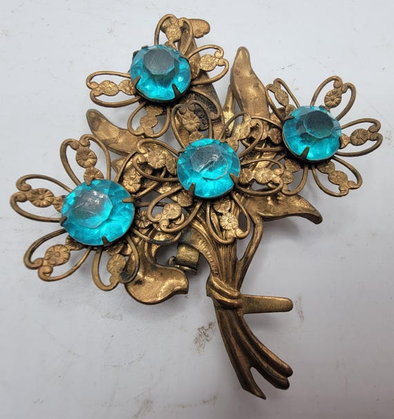 Antique Gold Metal and Teal Rhinestone Brooch - image 1
