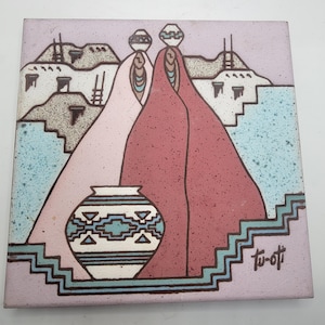 May include: A ceramic tile with a Southwestern design featuring two figures in pink and red robes carrying pots on their heads. The tile has a blue and white patterned pot in the foreground and the signature "Tu-o-ti" in the bottom right corner.