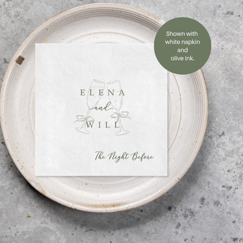 Personalized rehearsal dinner napkin in olive green ink, champagne flutes with bow accent, white napkin