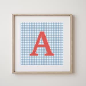 May include: A framed print with a red letter A on a blue and white gingham background.