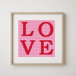 May include: Framed artwork with a red gingham background and the word "LOVE" in red letters.