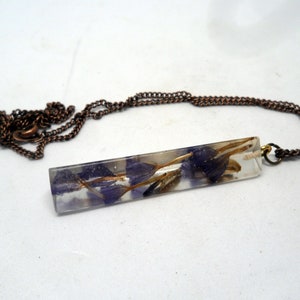 purple flowers in resin. long triangular necklace