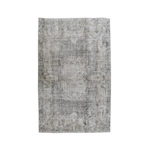 May include: A rectangular area rug featuring a distressed, faded gray and white color palette. The surface displays an intricate, symmetrical floral and medallion pattern with ornate borders, creating a weathered, aged appearance across the fabric.