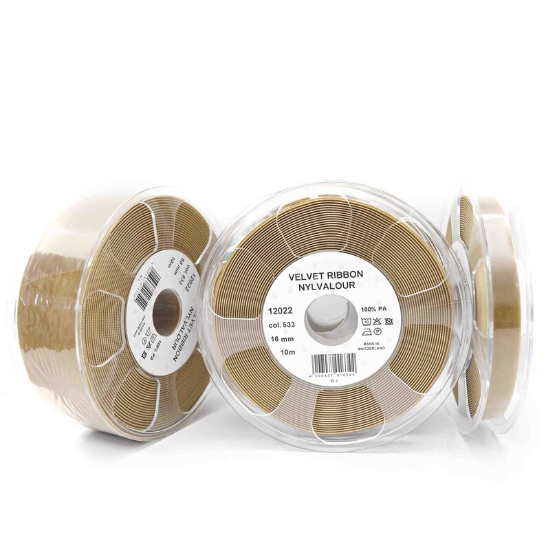 May include: Three spools of brown velvet ribbon, each in a clear plastic container. The label on the center spool reads "VELVET RIBBON NYLVALOUR 12022 col. 533 16 mm 10m 100% PA Made in Switzerland".