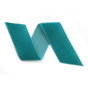 May include: A teal velvet ribbon, folded in a simple, elegant curve, isolated on a white background.