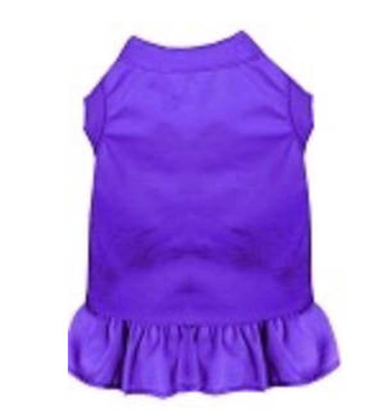 May include: A purple sleeveless dog dress with a ruffled hem.