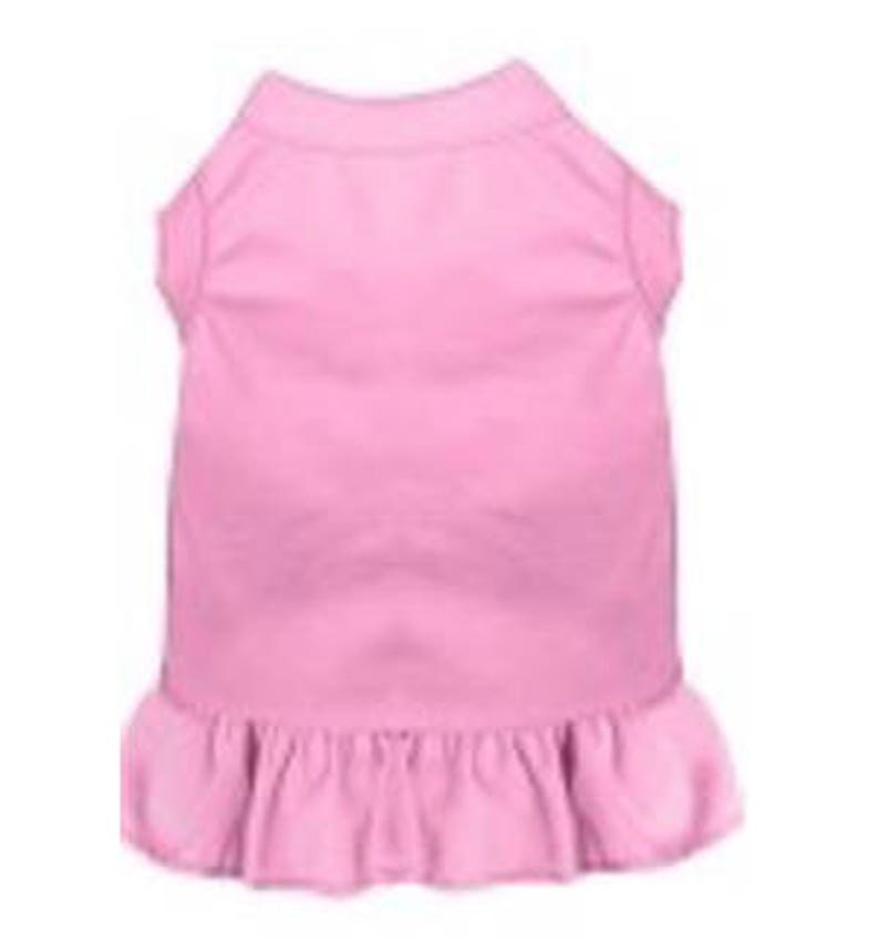 May include: A pink sleeveless dog dress with a ruffled hem.